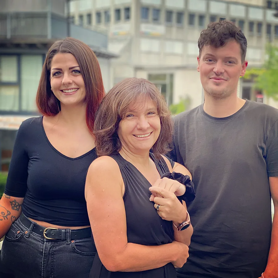 Drei Personen aus dem Team vor dem Studio